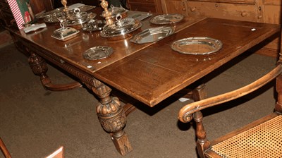 Lot 1310 - A Jacobean style carved oak refectory dining table with drawer leaves and pineapple supports, 330cm