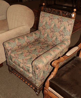 Lot 1318 - An early 20th century carved oak upholstered armchair