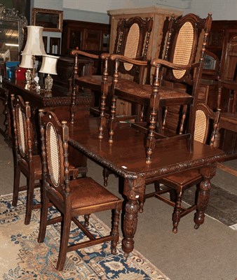 Lot 1320 - A carved oak dining table, 148cm by 104cm by 74cm together with six cane dining chairs, circa...