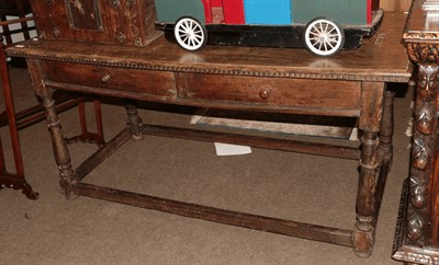 Lot 1322 - A late 17th/early 18th century walnut two-drawer table, raised on turned supports with bar...