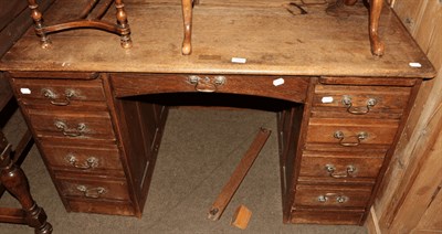 Lot 1325 - An early 20th century oak twin-pedestal desk, formerly a roll top desk, 125cm by 74cm by 78cm