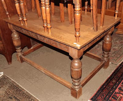 Lot 1330 - A carved oak refectory table with turned bulbous legs joined stretchers, 137cm by 90cm by 75cm