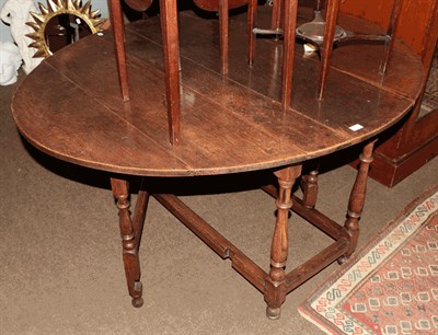 Lot 1333 - An early 19th century oak gateleg dining table, 148cm by 123cm by 73cm high