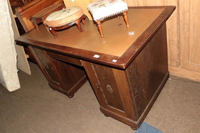 Lot 1340 - An early 20th century oak pedestal desk with leather insert, 141cm by 80cm by 79cm