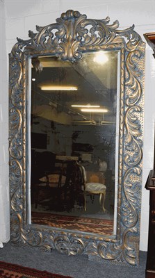 Lot 1347 - A large imposing parcel gilt mirror with scrolling open work pediment and further scroll work...