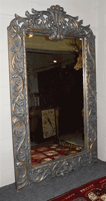 Lot 1348 - A large imposing parcel gilt mirror with scrolling open work pediment and further scroll work...