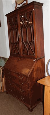 Lot 1357 - A George III mahogany bureau bookcase, the upper section with glazed astragal doors enclosing...