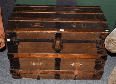 Lot 1362 - An early 20th century wood and metal bound American steamer trunk, 87cm by 53cm by 57cm