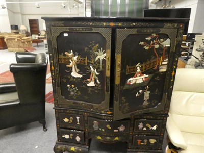 Lot 1366 - A Chinese lacquered serpentine cocktail cabinet with ivory and hard stone applied decoration...