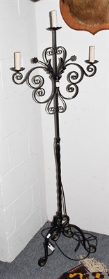 Lot 1382 - A wrought metal three light standard lamps formed as a candle stand, 161cm high