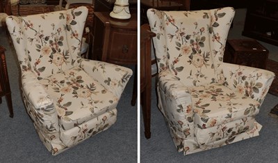 Lot 1390 - A pair of upholstered wingback armchairs (2)