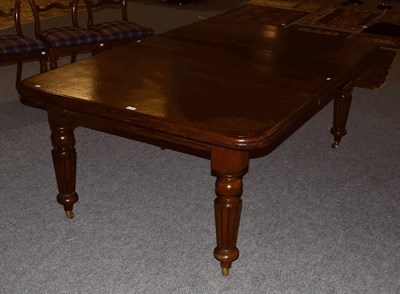 Lot 1393 - A Victorian mahogany wind out dining table with two additional leaves