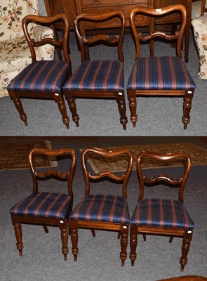 Lot 1394 - A set of six Victorian mahogany balloon back dining chairs, raised on turned supports