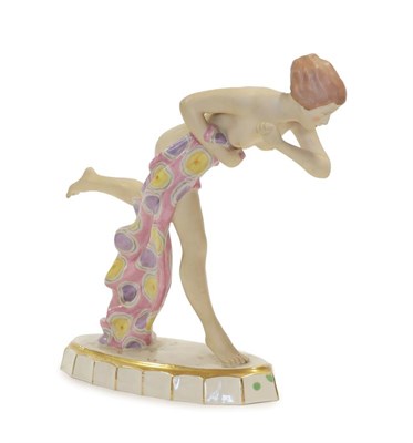 Lot 2039 - An Art Deco Royal Dux Figure, modelled as a nude young woman in a running pose, clasping a pink...