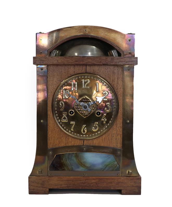 Lot 2059 - A German Arts & Crafts Oak and Brass Mantel Clock, probably retailed by Liberty & Co., the...