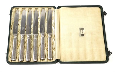 Lot 2073 - A Set of Six Arts & Crafts Liberty & Co, Silver Tea Knives, each with beaten handles, maker's...