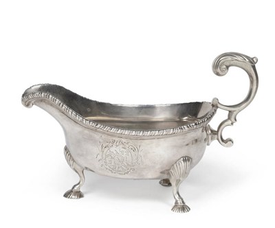 Lot 333 - A George II Sauceboat, maker's mark RI, London 1751, the three cast shell feet rising to a boat...