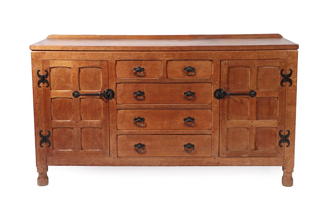 Lot 2191 - A Sid Pollard of Thirsk English Oak Panelled Sideboard, with raised upstand, above two short...