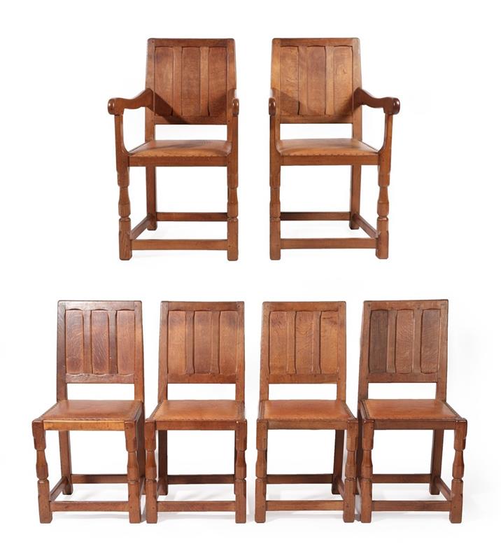 Lot 2193 - A Set of Six (4+2) Sid Pollard of Thirsk English Oak Panel Back Dining Chairs, studded tan...