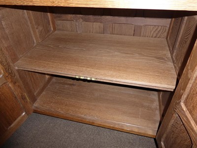 Lot 2197 - A Sid Pollard of Thirsk English Oak 5ft Panelled Dresser, the upper section with two shelves,...