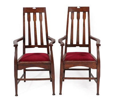 Lot 2214 - A Pair of Scottish Arts & Crafts Oak Dining Armchairs, with pierced top rail above three shaped...