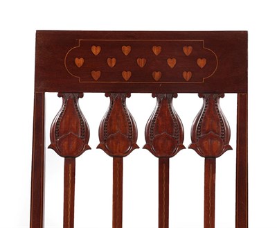 Lot 2222 - An Art Nouveau Mahogany Armchair, the top rail decorated with heart motifs, above carved flowerhead