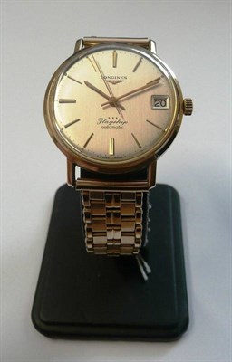 Lot 389 - A 9ct Gold Automatic Calendar Centre Seconds Wristwatch, signed Longines, model: Flagship,...