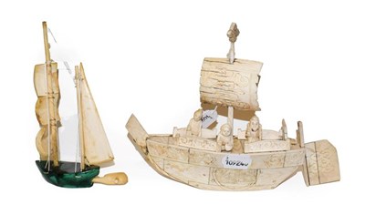 Lot 15 - A Chinese bone carved model of a boat with three figures, 18cm high and a similar with...