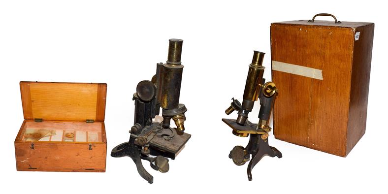 Lot 43 - A cased microscope by Baker, another by makers J Swift, cased quantity of microscope slides and...