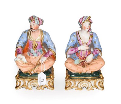 Lot 49 - A pair of Paris porcelain figures formed as a seated Turk and his companion, raised in gilt...
