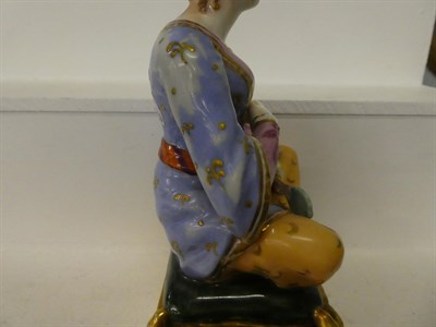 Lot 49 - A pair of Paris porcelain figures formed as a seated Turk and his companion, raised in gilt...