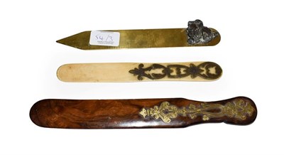 Lot 54 - A brass mounted olive wood page turner, a brass ruler mounted with a metal spaniel and another page