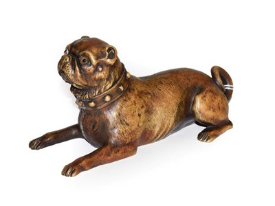 Lot 73 - A reproduction patinated metal model of a recumbent pug with glass eyes
