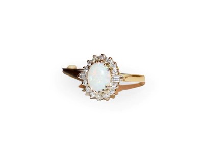 Lot 113 - An opal and diamond cluster ring, the oval cabochon opal in yellow claw settings, within a...
