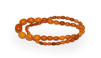Lot 117 - An amber bead necklace, length 65cm