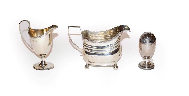 Lot 149 - A George III silver cream-jug, a Victorian silver cream-jug and a George III silver pepperette, the