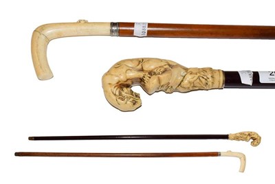 Lot 206 - An ivory mounted walking stick, circa 1900, the handle carved as a tiger above an ibex, 89cm...