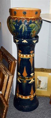 Lot 214 - A 19th century Continental earthenware jardiniere on stand, with incised decoration and...