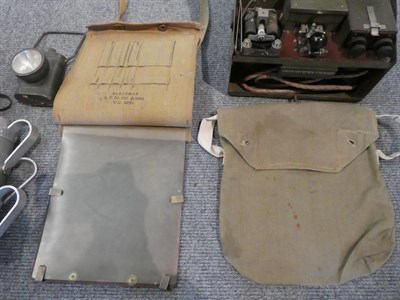 Lot 221 - A box of assorted militaria, including field telephone, gas masks, battle dress and a modern...