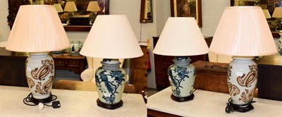 Lot 243 - A pair of modern Oriental style table lamps as blue and white vases and covers on wooden...