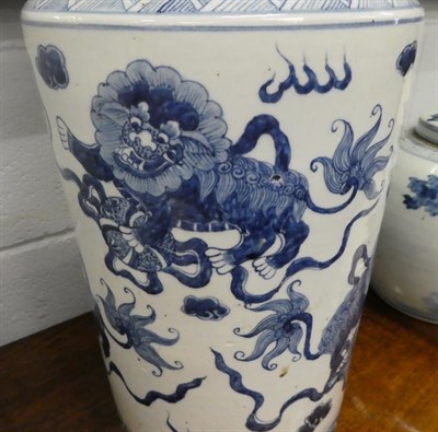 Lot 245 - A large Chinese blue and white cylindrical vase, painted in underglaze blue with dogs of fo, 51cm