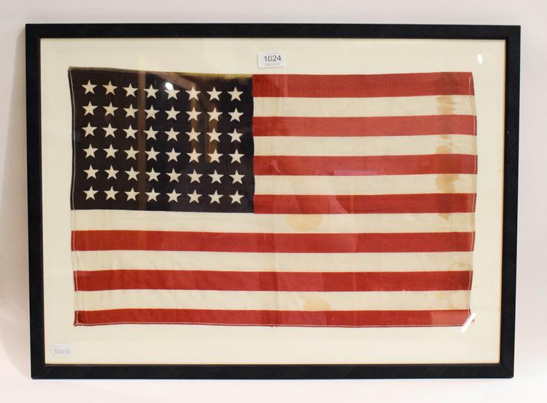 Lot 1024 - A stitched linen flag for the United States of America, 48 stars, 35cm by 57cm, (framed)