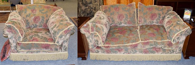 Lot 1069 - A chenille upholstered two-seater settee with bolster cushions and in stylized floral design, 193cm