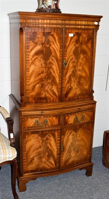 Lot 1081 - A reproduction mahogany veneered cocktail cabinet, 72cm by 37cm by 153cm high