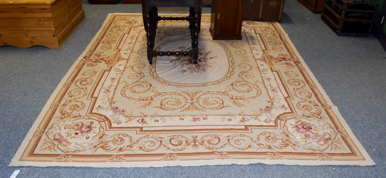 Lot 1097 - A modern needlepoint carpet of Aubusson design, the field of scrolling acanthus vines with oval...