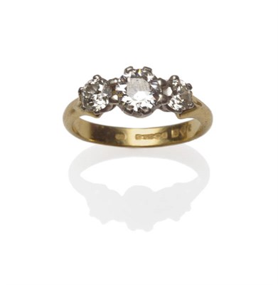 Lot 437 - An 18 Carat Gold Diamond Three Stone Ring, the graduated round brilliant cut diamonds in white claw