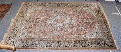 Lot 1106 - Kashmir silk piled rug, the coral pink field of vines centred by a cream medallion framed by...