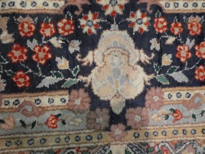Lot 1109 - A pair of Kirman design carpets, each with a cream field of vines around a central panel framed...
