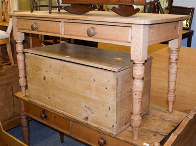 Lot 1135 - A Victorian pine two-drawer side table raised on turned supports, 137cm by 63cm by 76cm high