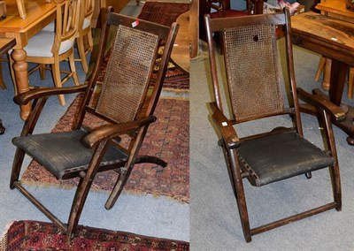 Lot 1149 - A pair of early 20th century teak and cane work folding steamer chairs
